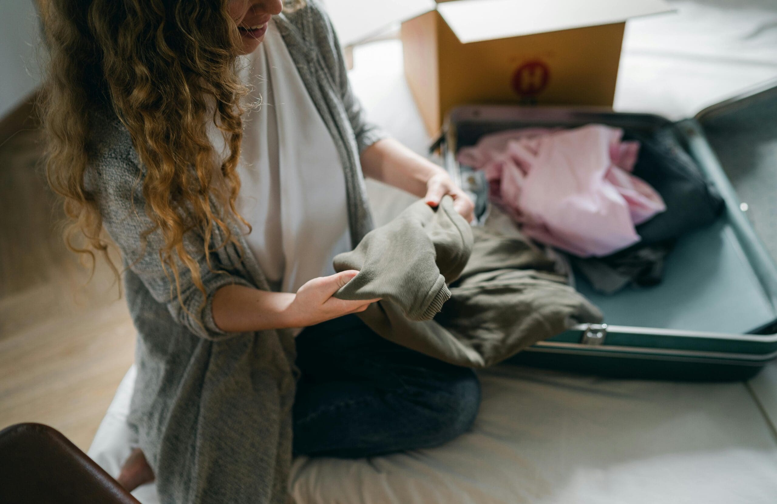 woman folding clothes and deciding what to pack for a mission trip