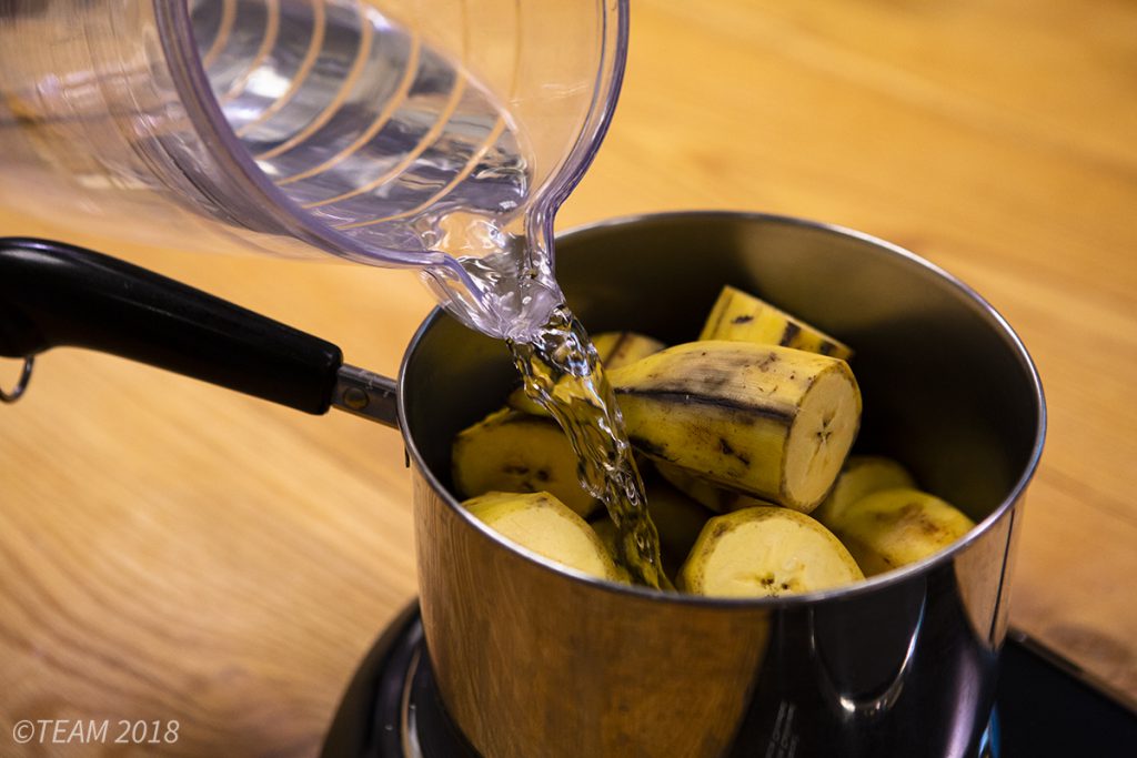 Add water to the chopped plantains
