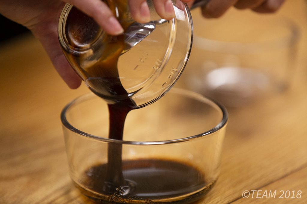 All of the ingredients for the sauce are mixed together in a glass bowl.