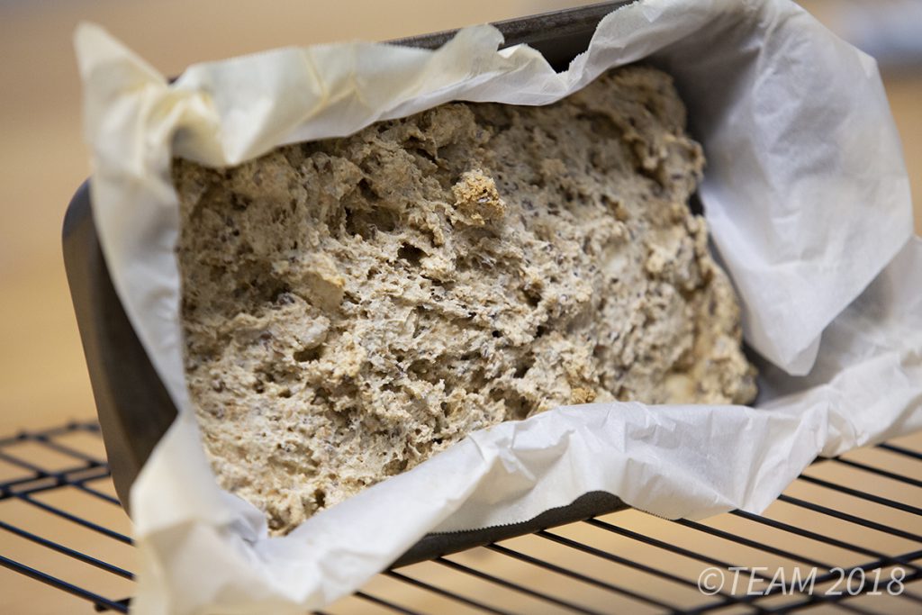 Let the bread cool propped up on it's side. This will help make it easier to remove it from the loaf tin