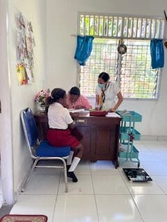 patient and medical staff sitting at a desk