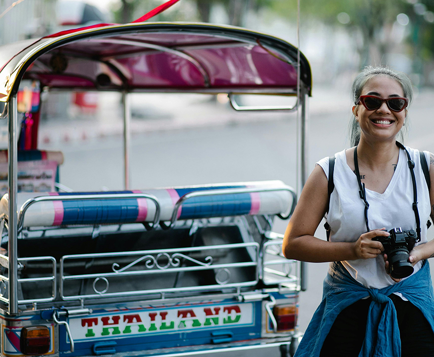 Woman next to a tuk tuk in Thailand