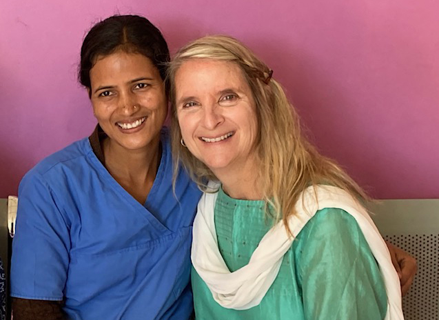 Rachel sitting next to a nurse doing mission work in South Asia