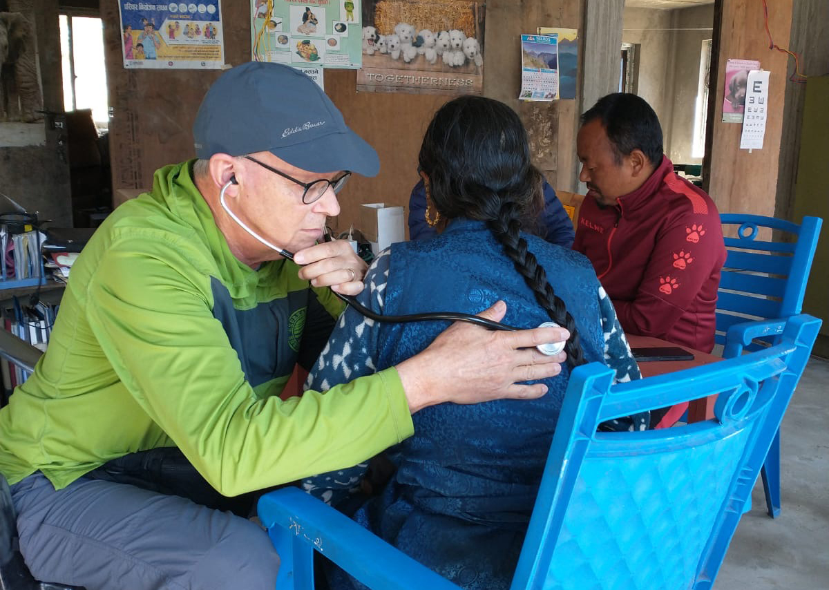 Man listening to a lady's lungs.