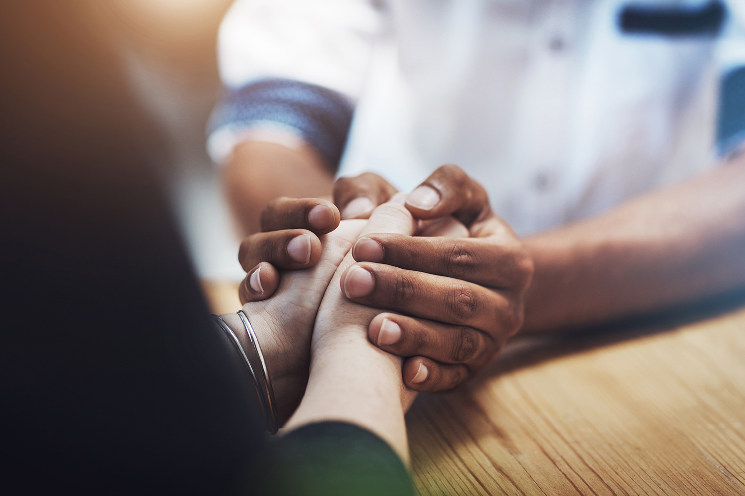 Hands holding one another.