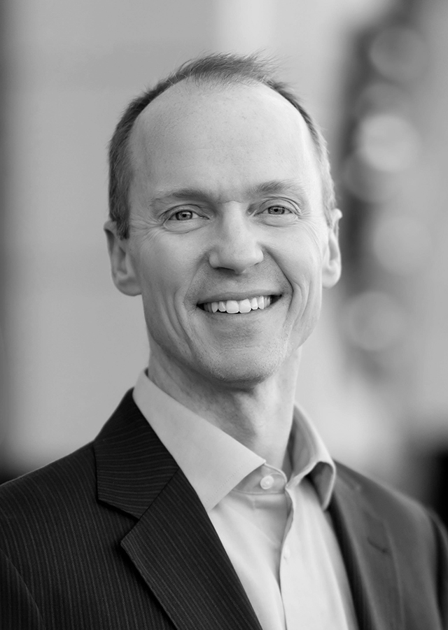 black and white portrait of Josh Heidelman smiling
