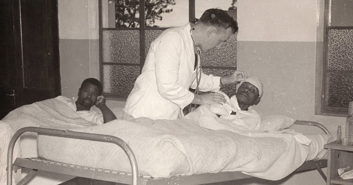 doctor treating patients laying in bed working medical missions on avenue of service to God