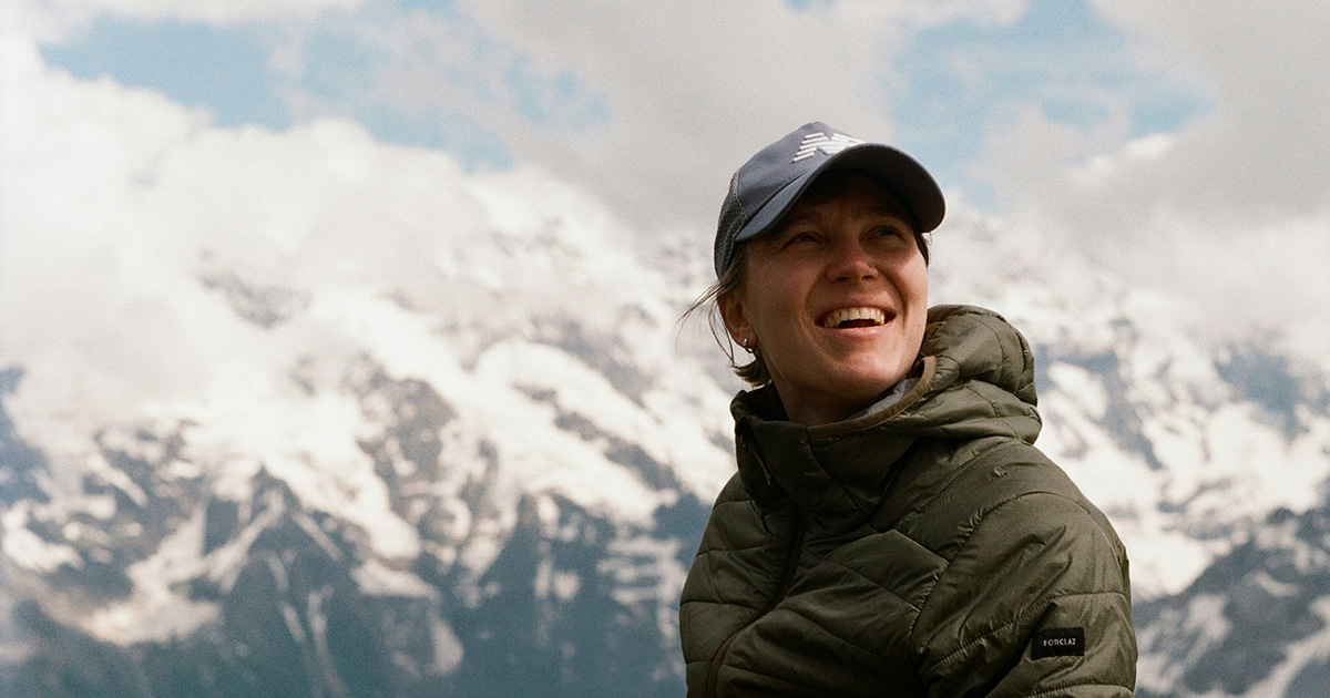 woman on mountaintop smiling into the distance