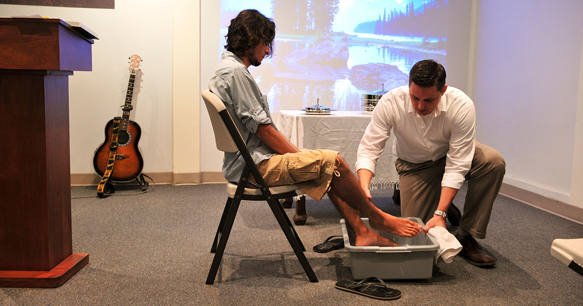 a man washing another person's feet in a missional church