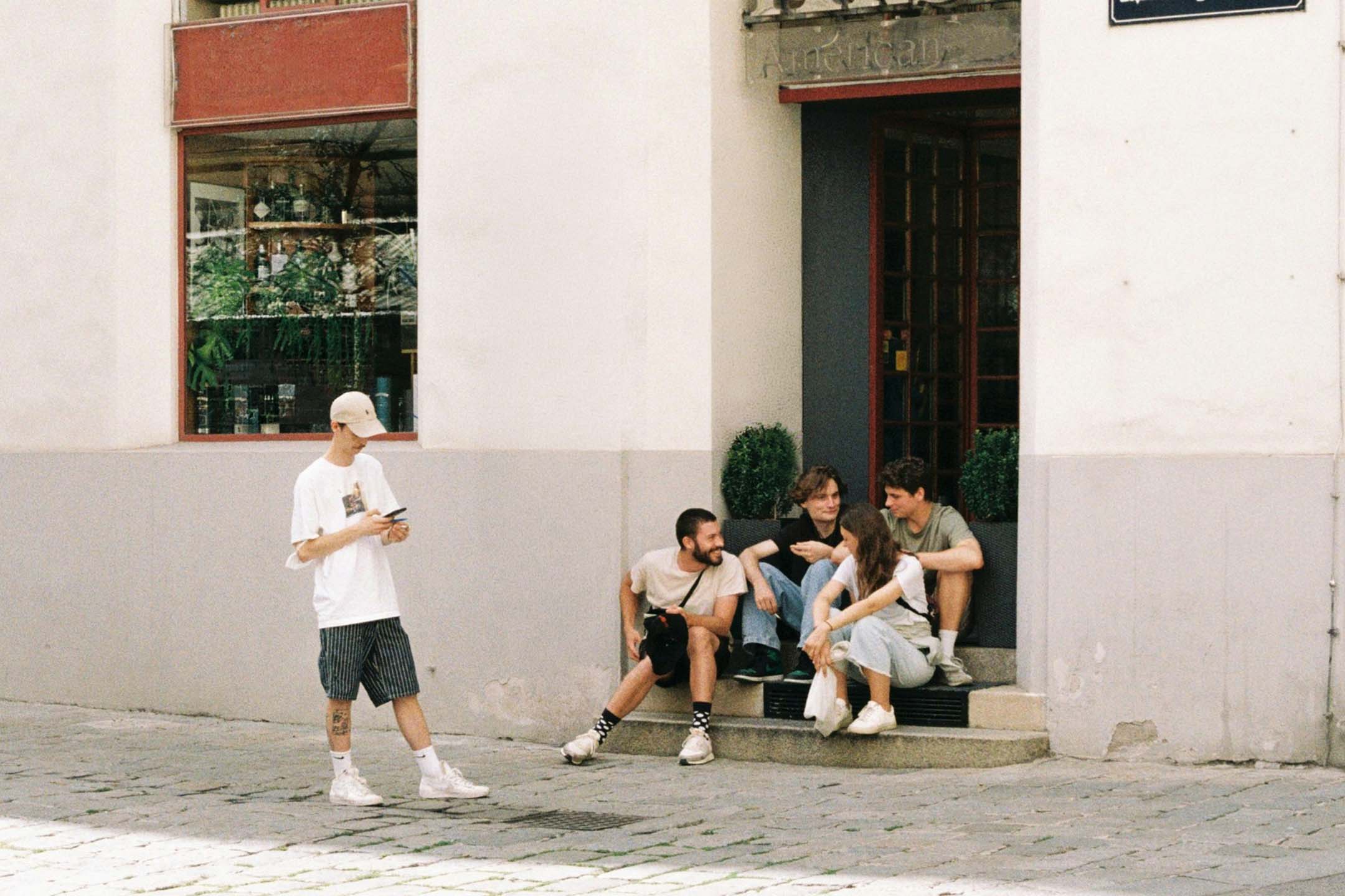 group of young people sitting on steps in Austria